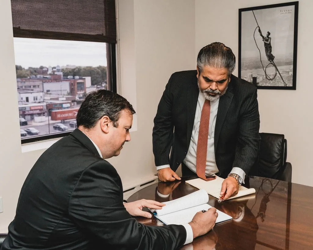 The partners review documents at the Hempstead office.