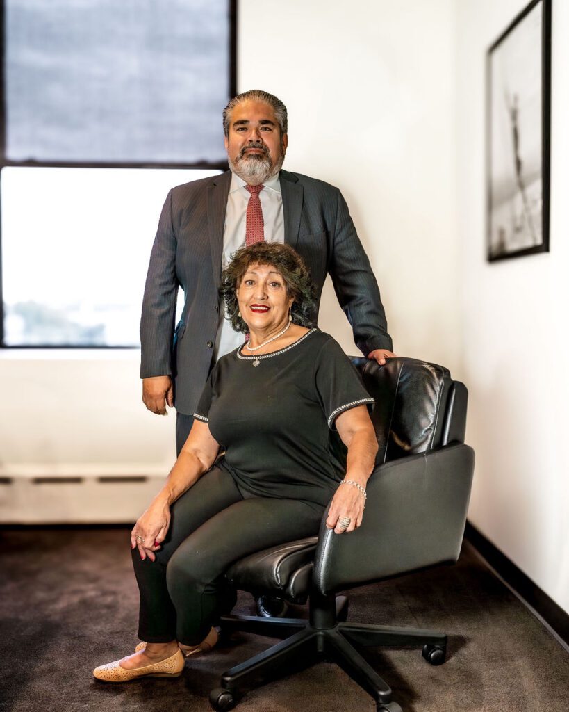 Cesar Valdebenito with his mom sitting on a chair Photo